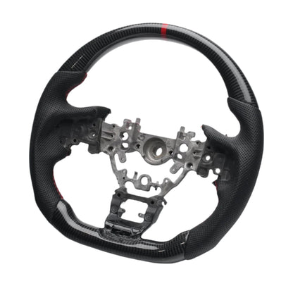 Carbon fiber steering wheel with metal center on a white background

