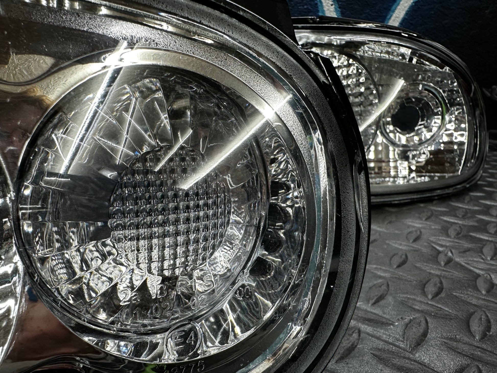 Detail view of the round lamp section of the NA Miata clear tail light showing marks on the inside of the lens