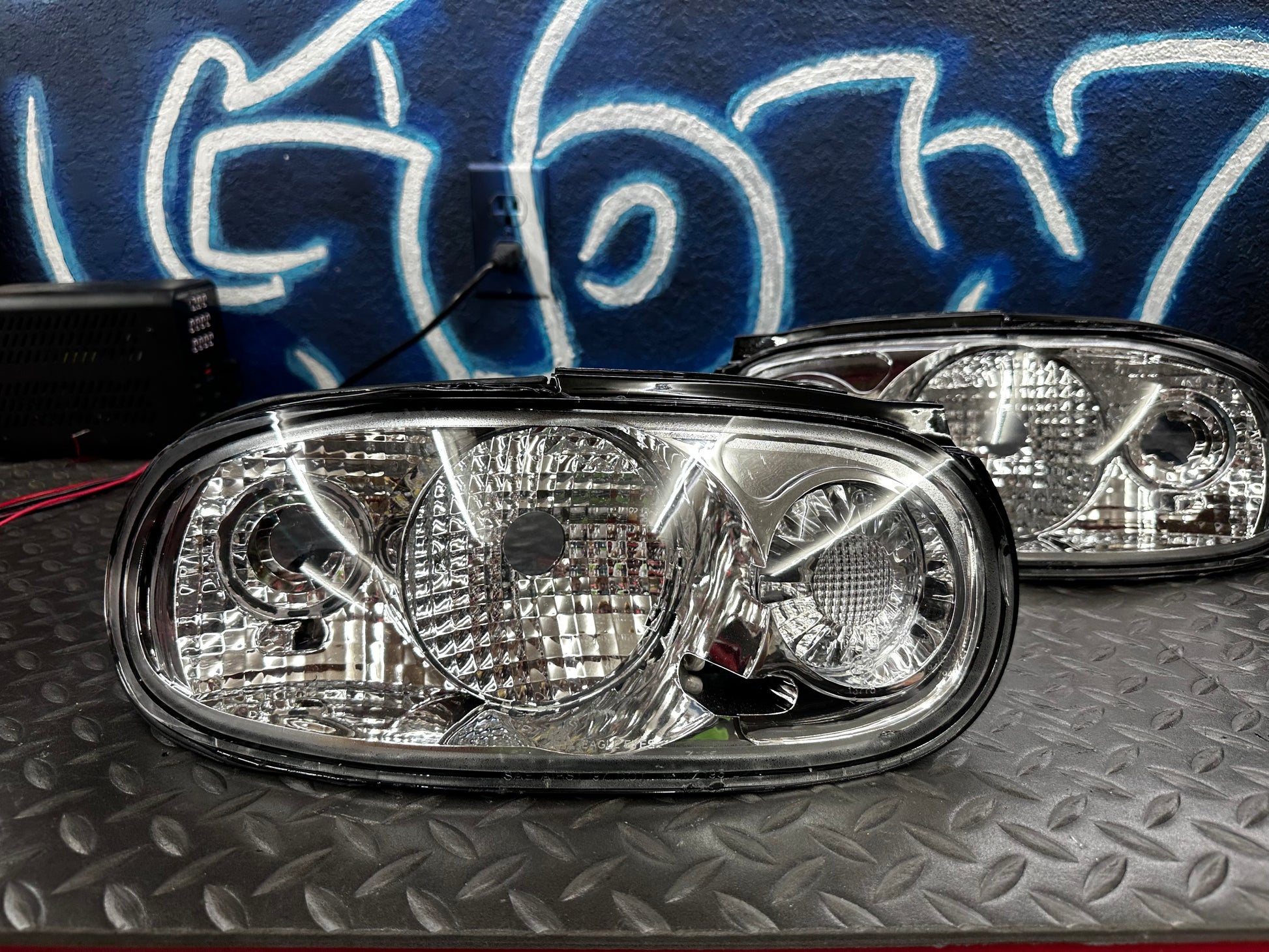 Driver and passenger clear tail lights for the NA Mazda Miata shown together as a pair